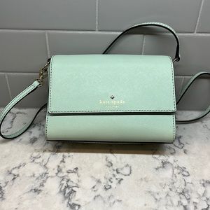 Small Kate Spade purse in sea foam greens.  Black polka dot interior